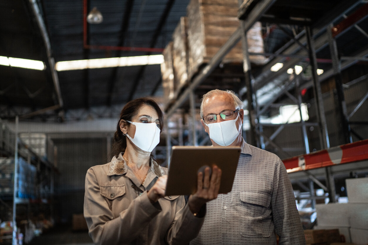 nike business continuity plan Senior partners using a tablet to look for vulnerabilities in supply chain
