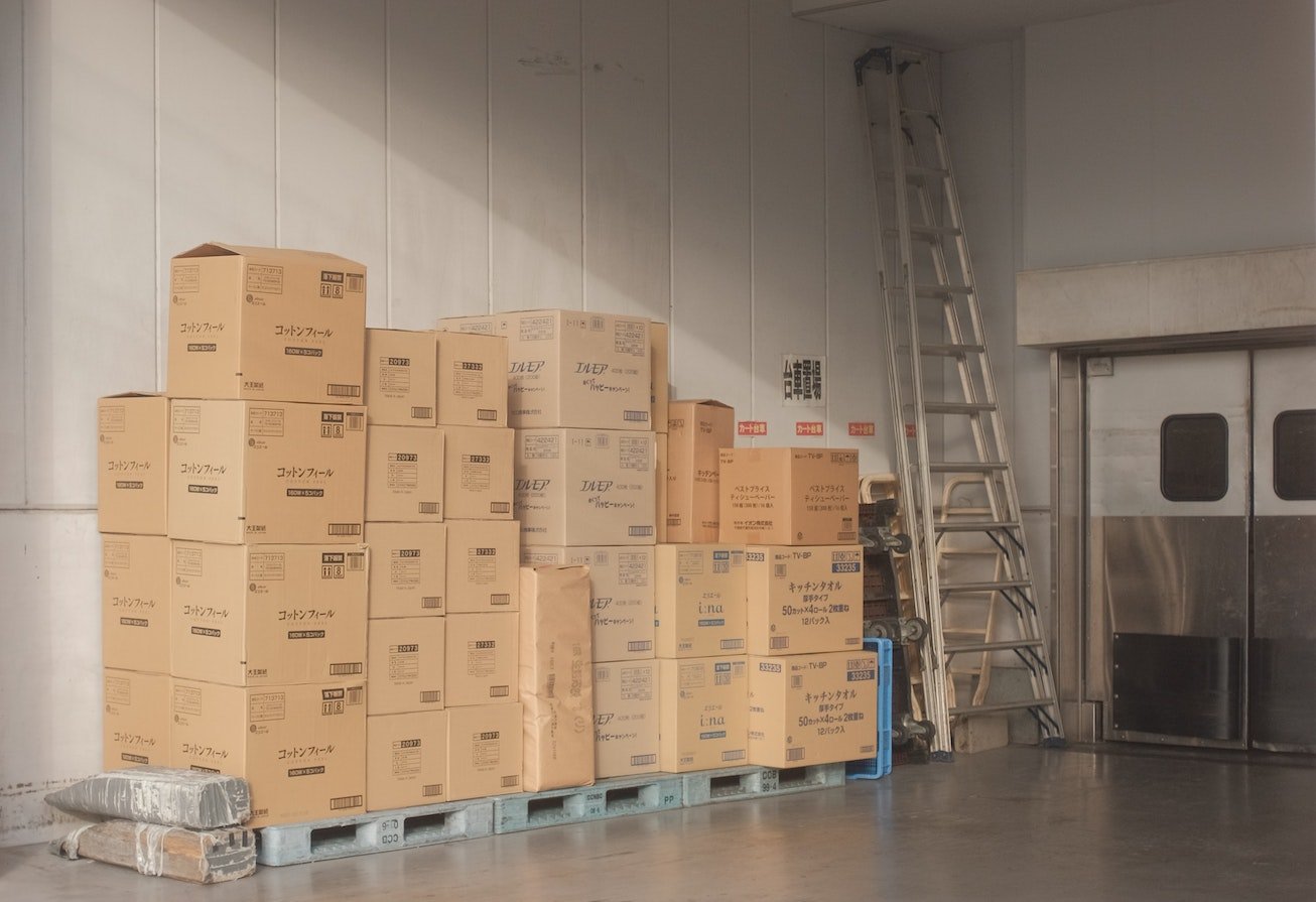 Warehouse operator using a warehouse lien to keep a client's stored goods until outstanding fees are paid - boxes stacked in warehouse