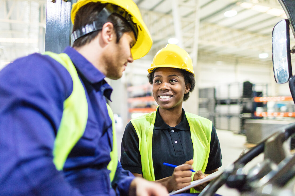 Warehouse workers discussing tips for maintaining safety in the warehouse