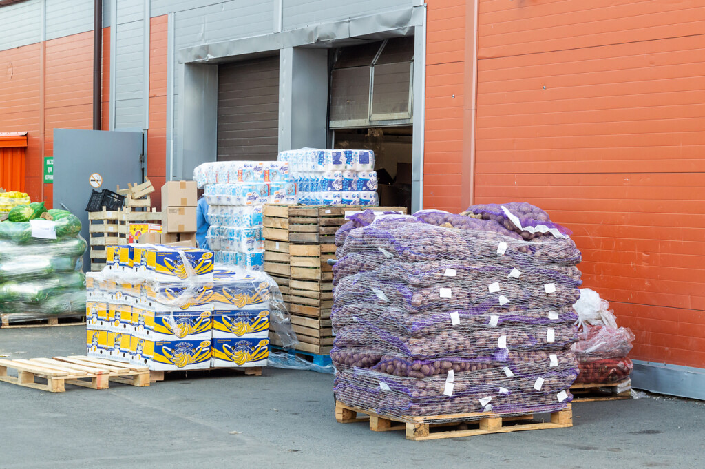 Various goods on pallets in front of the warehouse.