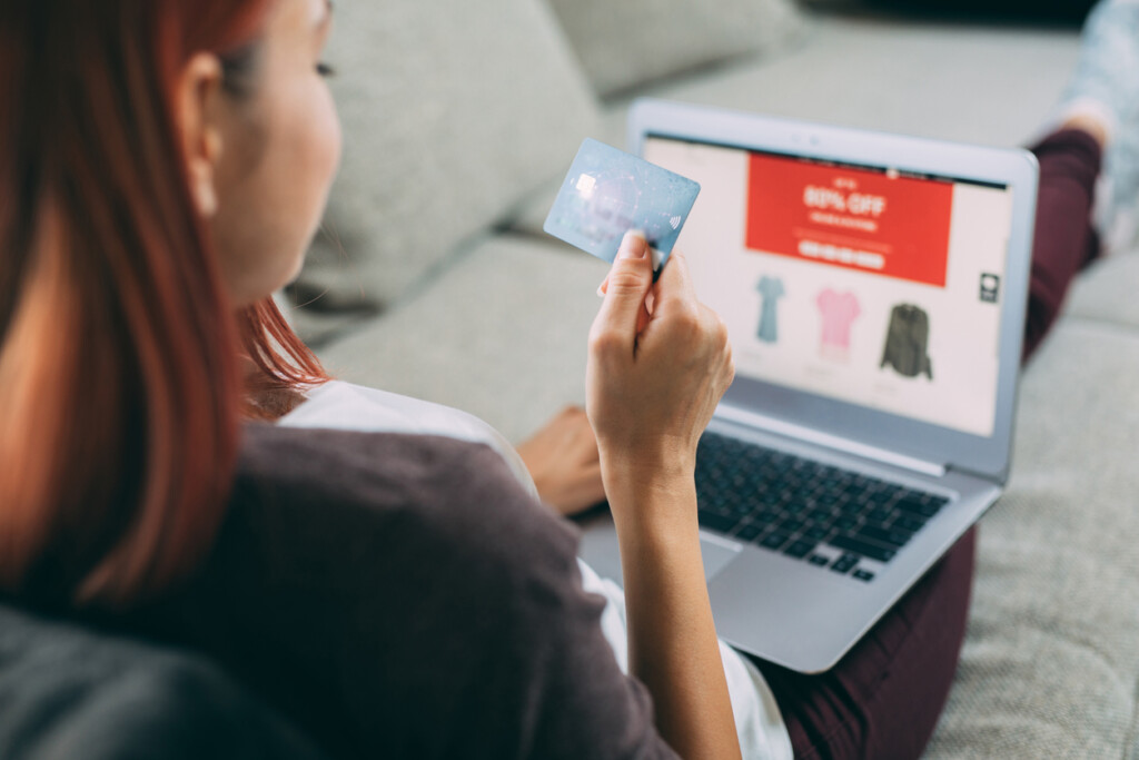 Woman making online payment via laptop at home.