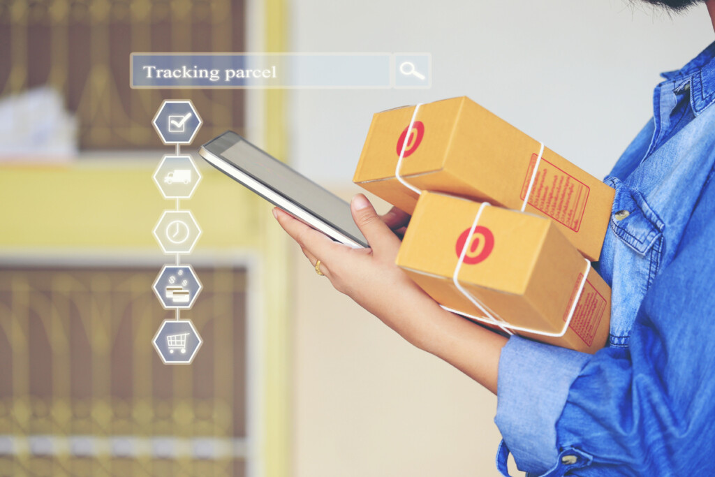 Online shopping, Woman hand holding smart phone and tracking parcel online to update status with hologram, last-mile E-commerce and delivery service status tracking concept