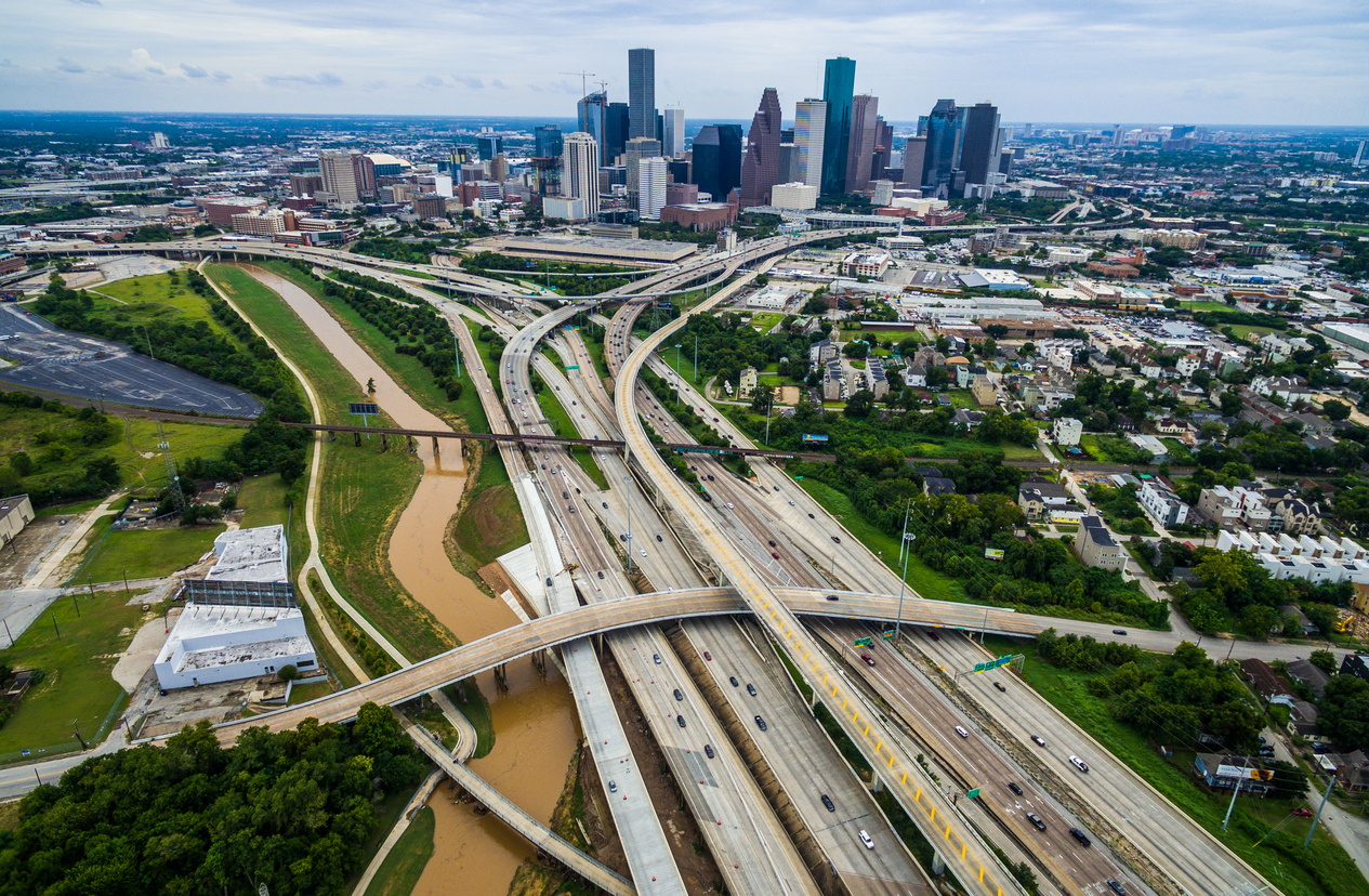 Aerial view of Houston, Texas, showcasing its expansive road network, bustling traffic, and towering skyscrapers, emphasizing the pivotal role of a reliable 3PL partner in managing logistics and transport operations.