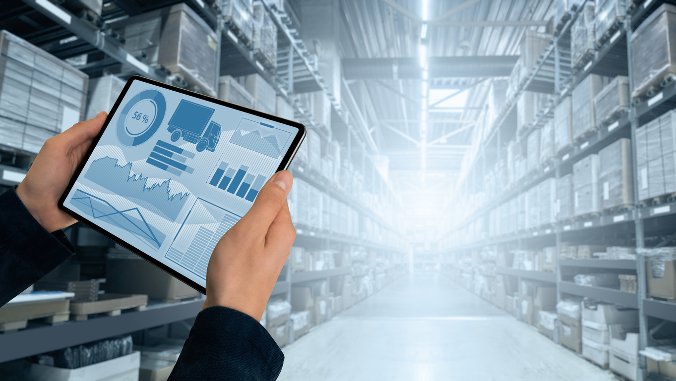 Warehouse manager with digital tablet doing 3PL performance reporting on inventory