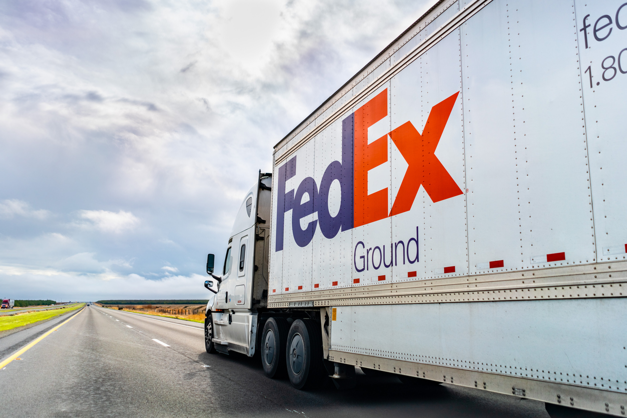 FedEx Ground truck driving on the interstate, illustrating the shift in shipping modes that affects fulfillment strategy.