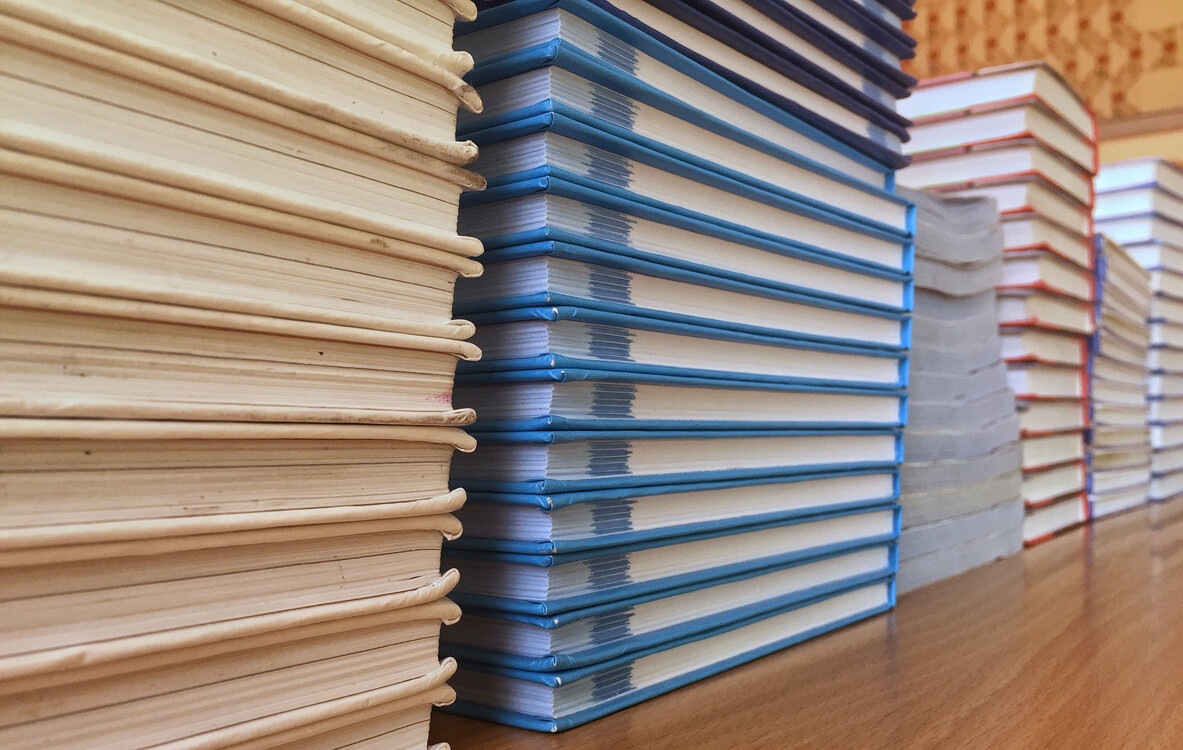 Stacks of textbooks representing publisher fulfillment inventory organized for efficiency.