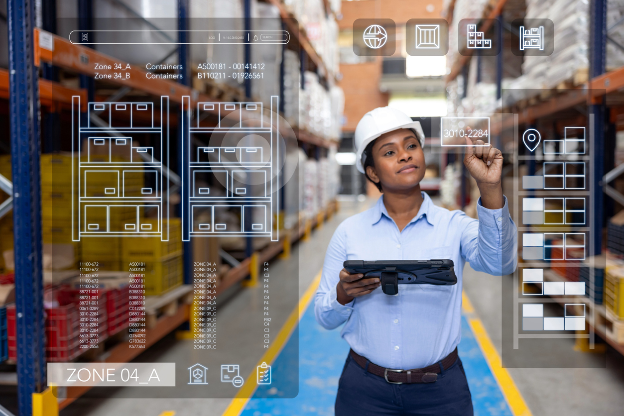 Warehouse worker reviewing an orders list and tracking shipments on a tablet, illustrating visibility score and transparency in supply chain KPIs.