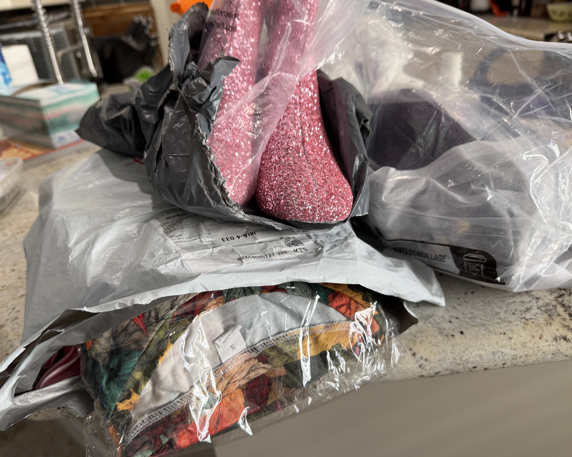 Assorted online retail returns in shipping bags on a countertop, illustrating the volume of returns brands manage after peak season.